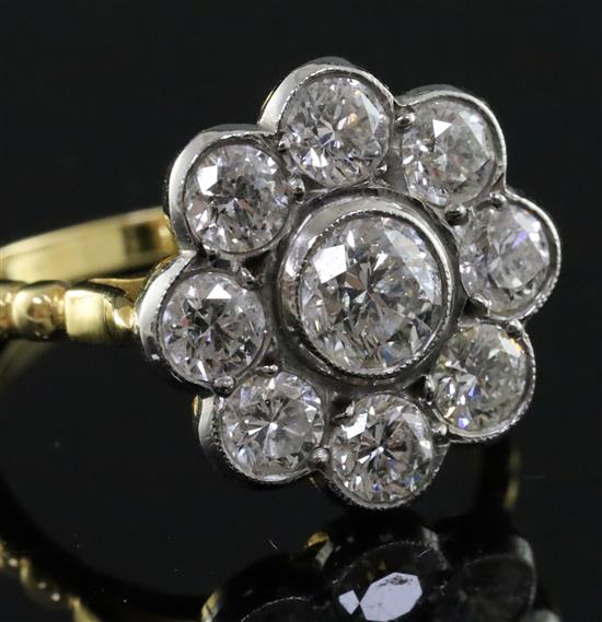 An 18ct gold and diamond cluster flowerhead ring, size N.